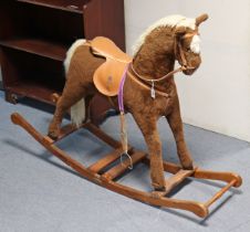 A fabric-covered rocking horse on a pine base, 110cm high (slight faults).