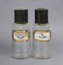 A pair of vintage clear-glass apothecary jars each with a verre eglomise label & a japanned-metal