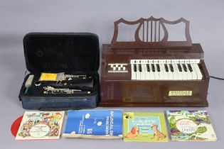 An Artemis ebonised clarinet with chrome plated keys, cased; & a Rosedale “Electric chord organ”.
