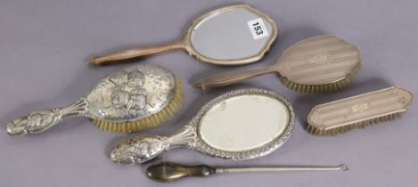 An Edwardian silver-backed hand mirror & hairbrush each with embossed cherub design Chester 1906;