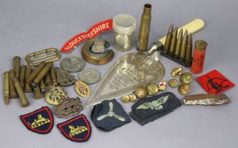 A collection of British military tunic buttons and cloth badges, a late 19th century silver plated