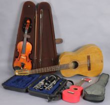 A Selmar ebonised clarinet with chrome plated keys; a modern violin; an acoustic guitar; & a