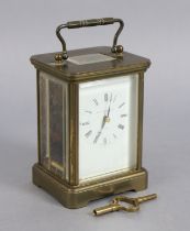 A Matthew Norman of London brass-cased carriage timepiece with black roman numerals to the white