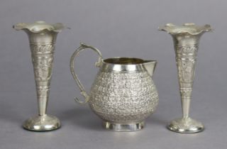 An antique Indian silver globular cream jug with embossed foliate decoration, 8cm high, and a