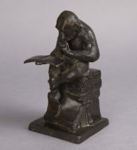 A bronzed sculpture in the form of a seated character ape reading a book, after Mene, 19.25cm high.