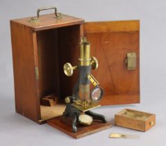 An early 20th century black lacquered steel student’s microscope with brass fittings & with a