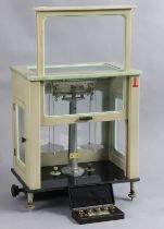 A modern Stanton’s of London laboratory balance in a grey polished case, 39 cm wide x 47 cm high.