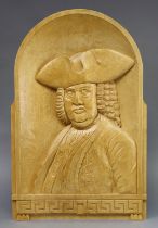 A relief-carved softwood rectangular plaque depicting half-length portrait of Beau Nash, signed with