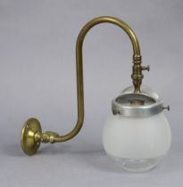 An Edwardian brass wall-mounted gas lamp with a glass globular shade, 26cm high.