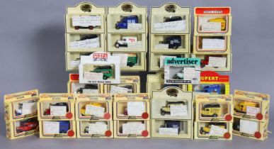 Thirty various Lledo die-cast scale model delivery vans, each with a window box.