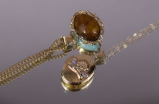 A 14k oval pendant set pale blue hardstone cabochon to one side, amber to the other, on gilt-metal