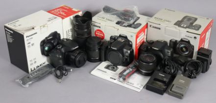 A Canon EOS 1300D digital camera; a Canon 1200D ditto; a Panasonic Lumix DC-F282 digital camera; and