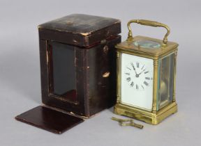 A French carriage clock in gilt-brass case, eight-day movement with push-button repeat striking a