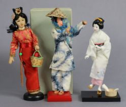 Three small oriental dolls.