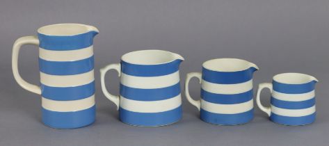 Four T.G. Green blue & white banded Cornish ware jugs (various sizes).