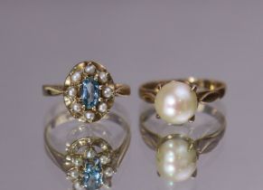 A 9ct gold ring set oval-cut pale blue stone within a seed-pearl border, size: K (2gm); & a 9ct.