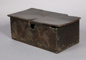 A 17th century oak bible box with carved foliate decoration, the hinged lift-lid with moulded