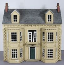 A painted wooden two storey dolls-house with an opening front & hinged roof, 85cm wide x 77cm high x