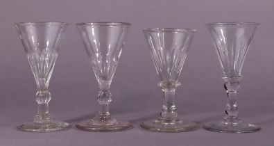 A pair of 18th century English drinking glasses, each with conical bowl on spiral-fluted knopped