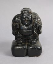 A Japanese carved wood & black lacquered figure of Daikoku, with old inscription to base "Idol – God