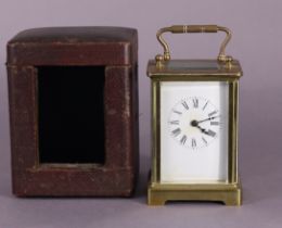 A late 19th century brass-cased carriage timepiece, 12cm high, in red morocco travelling case.