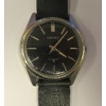 A Seiko stainless steel cased wristwatch, faced by a black baton dial, on a black hide strap