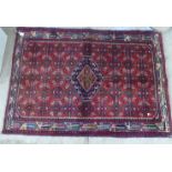 A Persian Senne rug, on a red ground  40" x 57"