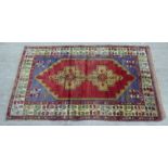 A Persian rug, decorated with stylised designs, on a multi-coloured ground  46" x 75"