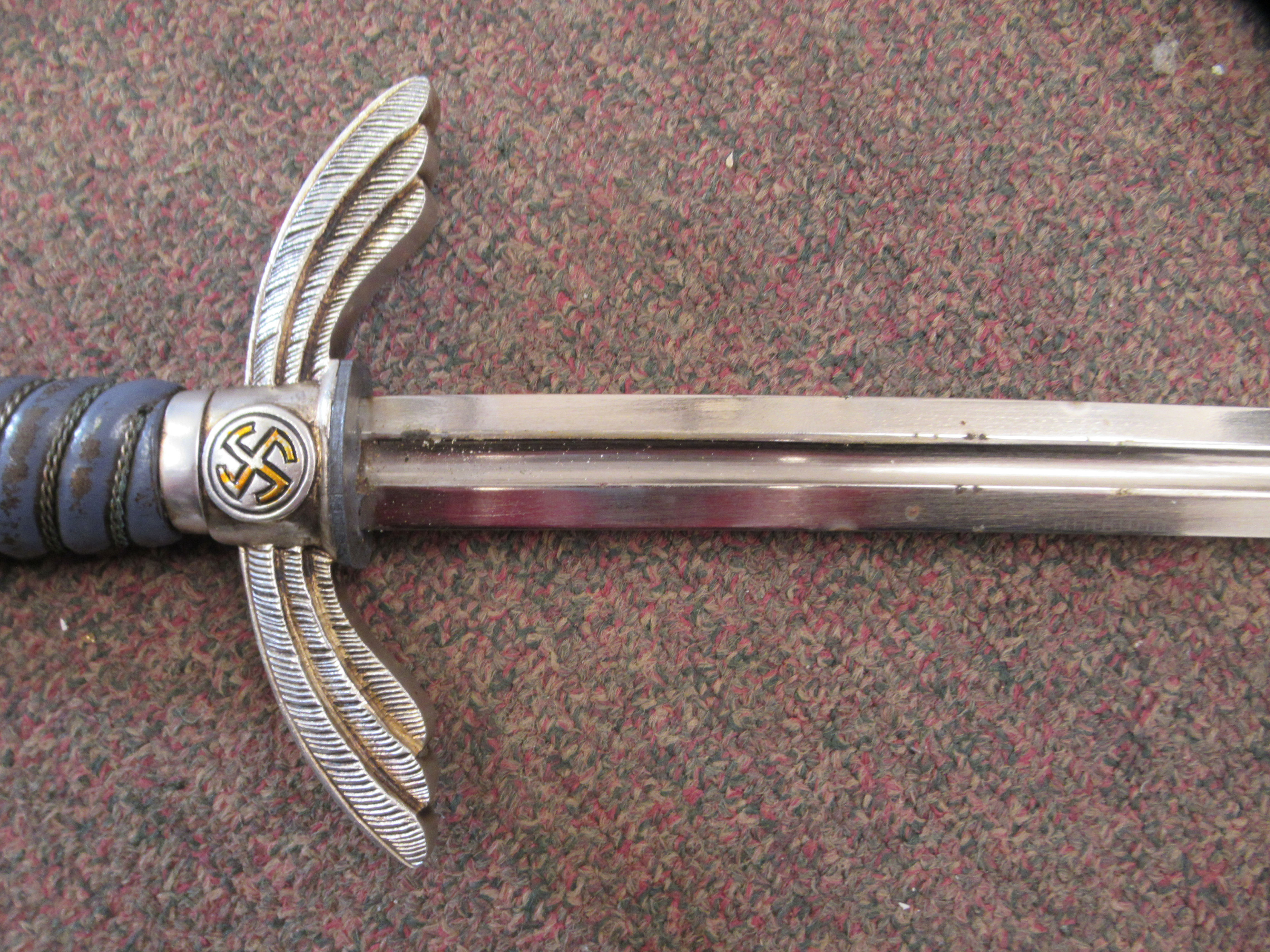 A German Luftwaffe dress sword with swastika emblems on the pommel and hilt, a woven wire bound - Image 5 of 7