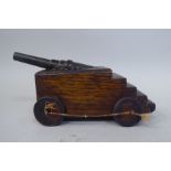 A late 19thC scratch built model canon, the bronze barrel set in an oak block carrier with wooden