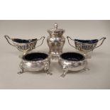 Two pairs of dissimilar silver salt cellars with blue glass liners; and a silver pepper mill of