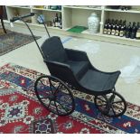 A Victorian child's pushchair, on a three wheeled sprung chassis
