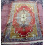 A Persian rug, decorated with stylised designs, on a multi-coloured ground  46" x 75"