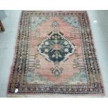 A Hamadan woollen rug, decorated with floral motifs, on a pink ground  50" x 45"