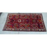 A Turkish rug, decorated in bright colours with geometric shapes  47" x 82"