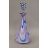 In the manner of Nailsea, a glass decanter of conical form with a stopper, decorated in tones of