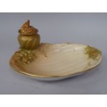 A late 19thC Royal Worcester blush, ivory glazed and gilded china inkwell, on a floral decorated,