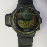 A Casio Prayer Compass wristwatch, faced by a digital dial, on an integral strap