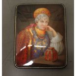 A Russian folding card case, the top finely painted, depicting a fortune teller, on a black