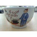 An 18thC English porcelain footed tea bowl, decorated in Chinese taste with various figures