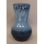 A Royal Lancastrian pottery streaky and drip glazed blue vase of squat, bulbous form with a wide,