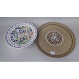 A Poole pottery stoneware cake plate, decorated with moulded and incised designs  bears an impressed