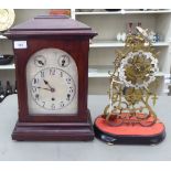 An early 20thC lacquered brass skeleton clock of scrolled design; the single fusee, bell strike