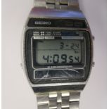 A Seiko stainless steel cased bracelet watch, the alarm chronograph movement faced by a digital dial