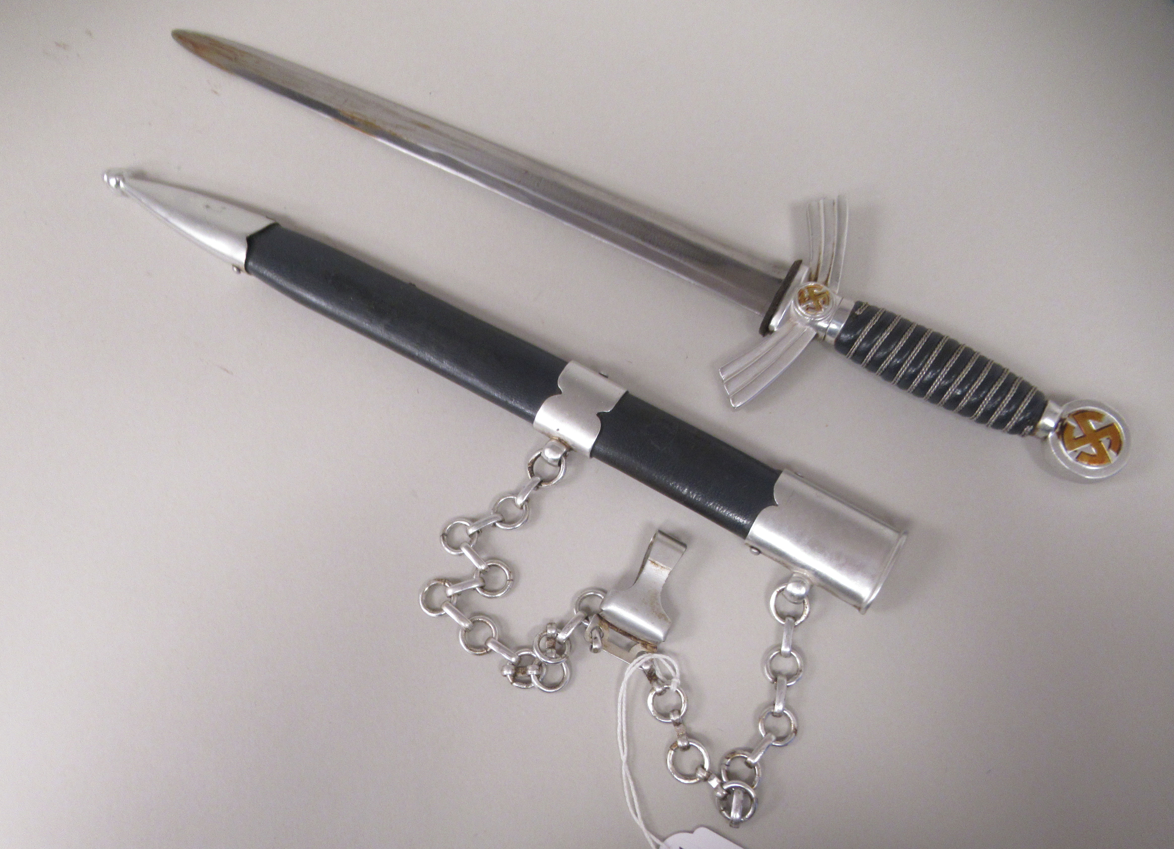 A German SS dress dagger with swastika emblems on the pommel and hilt and a woven wire band