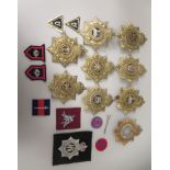 Eight British military regimental helmet plates: to include Middlesex, West Surrey and The Buffs