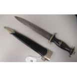 A German SS dagger with emblems and a moulded hardwood grip, the 8.75"L blade bears a motto, in a