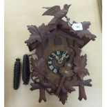 A mid 20thC Black Forest cuckoo clock, carved with birds and leaves  17"h