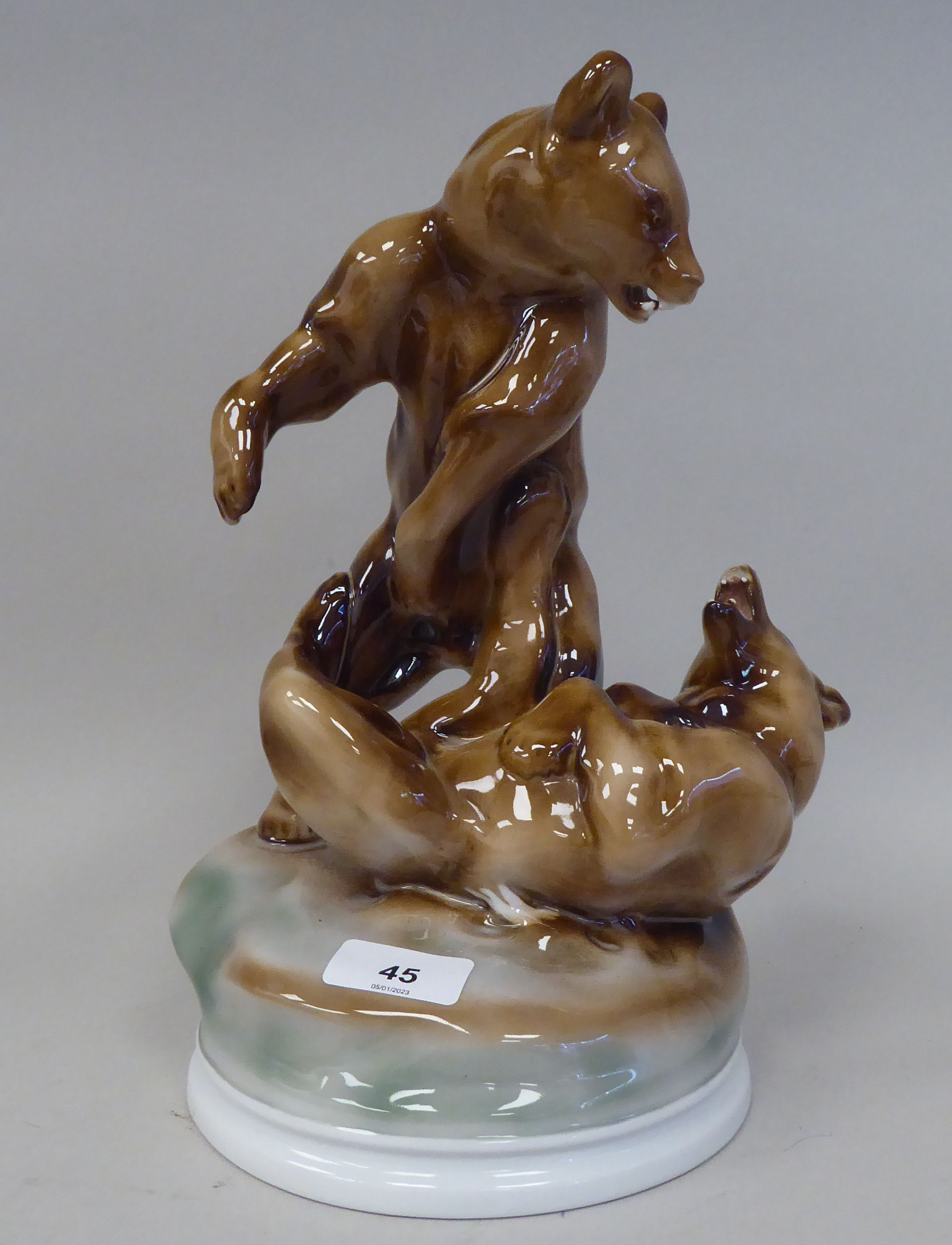 A Zsolnay Pecs porcelain group, two fighting brown bears, on a circular base  bears a printed