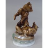 A Zsolnay Pecs porcelain group, two fighting brown bears, on a circular base  bears a printed